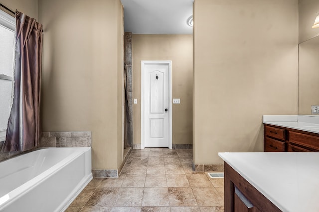 bathroom with shower with separate bathtub and vanity