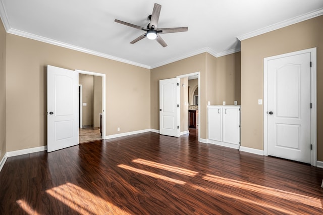 unfurnished bedroom featuring ceiling fan, dark wood-type flooring, and crown molding