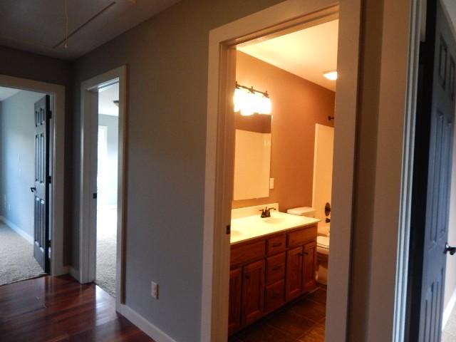 bathroom featuring hardwood / wood-style floors, vanity, and toilet