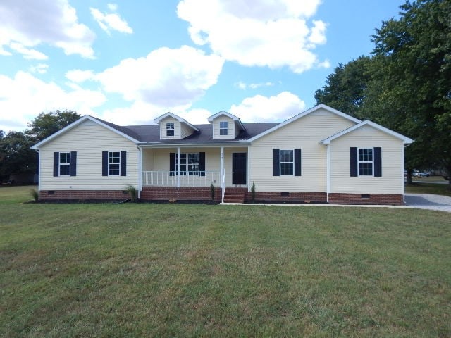 view of front of property with covered porch and a front yard