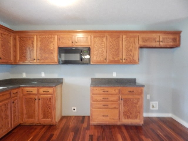 kitchen with dark hardwood / wood-style flooring