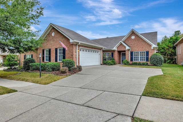 view of front of home with a garage and a front lawn