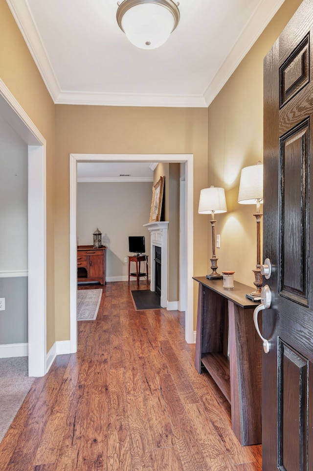 hallway with crown molding and dark hardwood / wood-style floors