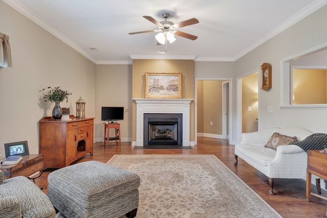 living room featuring ornamental molding, ceiling fan, and hardwood / wood-style flooring