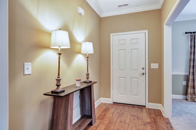 entryway with crown molding and hardwood / wood-style floors