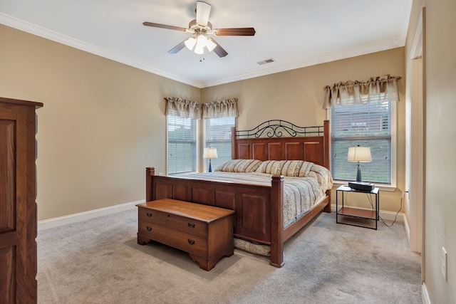 carpeted bedroom with ceiling fan and crown molding