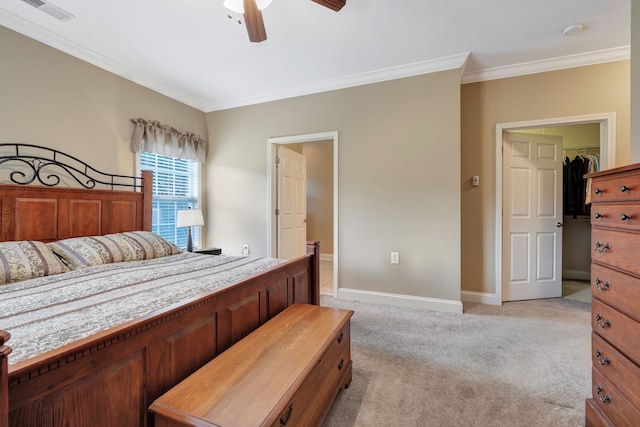 bedroom with a closet, light carpet, crown molding, a spacious closet, and ceiling fan