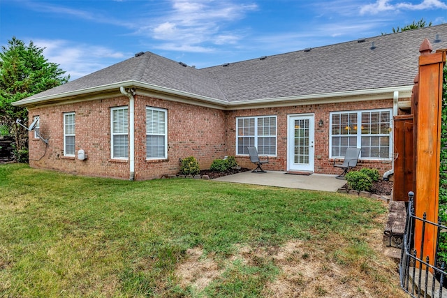 back of property featuring a yard and a patio area