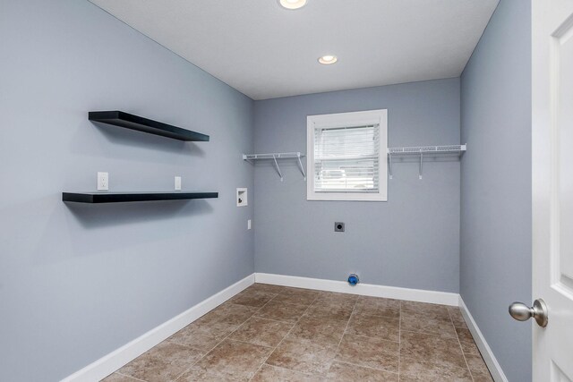 clothes washing area featuring hookup for a washing machine and electric dryer hookup