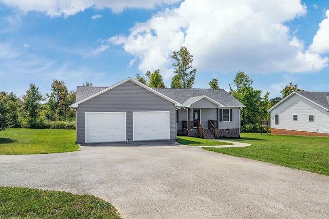 view of front of house with a front yard and a garage