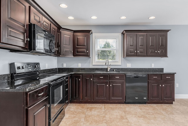 kitchen with dark stone counters, sink, black appliances, dark brown cabinetry, and light tile patterned floors