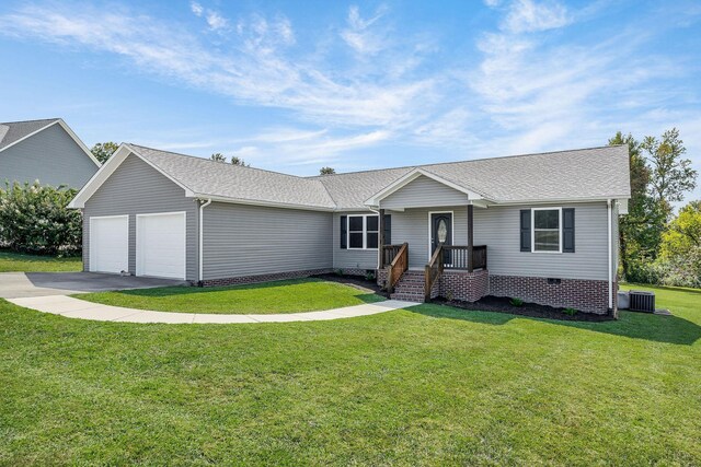 ranch-style home featuring a front yard, central AC unit, and a garage