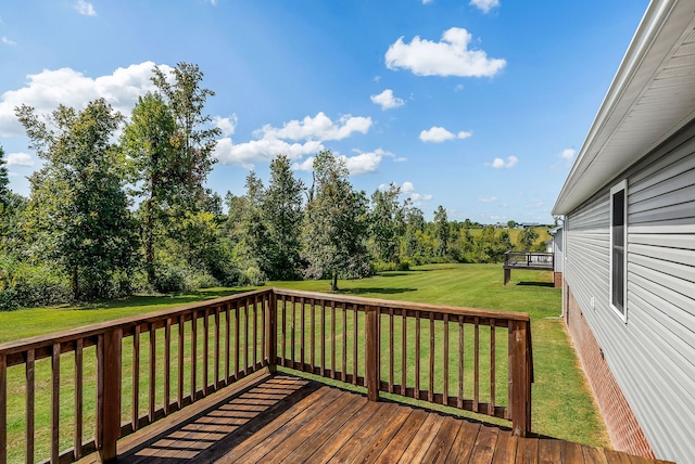 wooden deck featuring a lawn