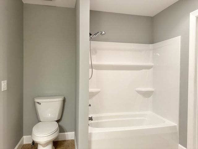 bathroom with tub / shower combination, toilet, and tile patterned floors