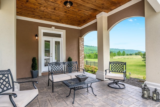 view of patio / terrace featuring a mountain view and french doors