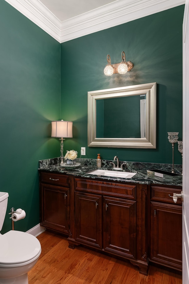 bathroom with vanity, crown molding, toilet, and hardwood / wood-style flooring