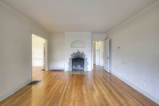 unfurnished living room with light hardwood / wood-style flooring and ornamental molding