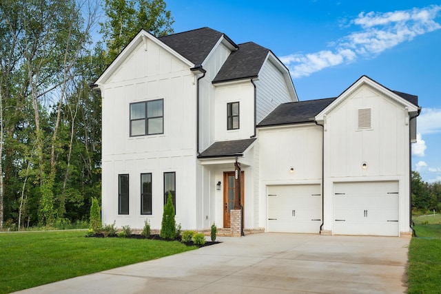 modern inspired farmhouse with a front lawn and a garage