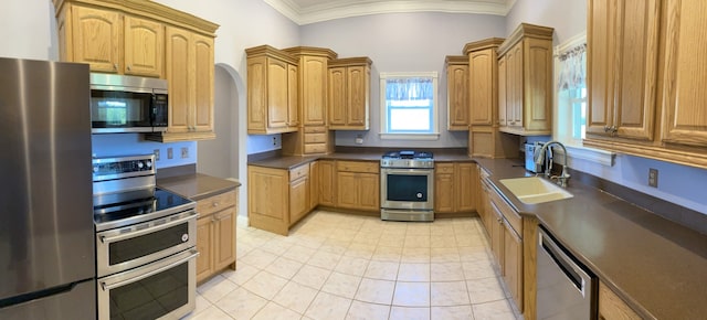 kitchen featuring crown molding, sink, light tile patterned floors, and stainless steel appliances