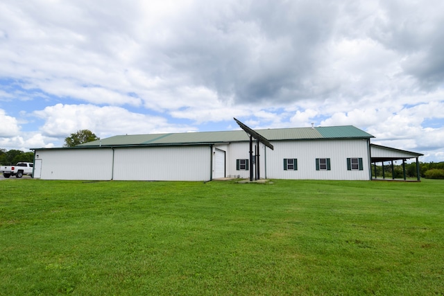 rear view of property featuring a lawn