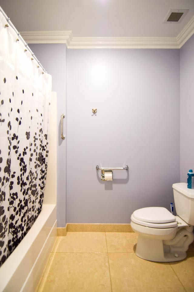 bathroom with shower / bath combo, tile patterned flooring, crown molding, and toilet