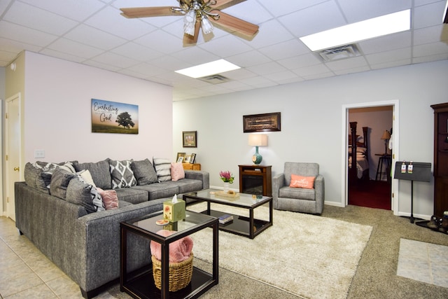 living room featuring a paneled ceiling and ceiling fan