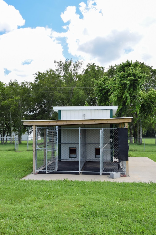 exterior space featuring a lawn and an outdoor structure