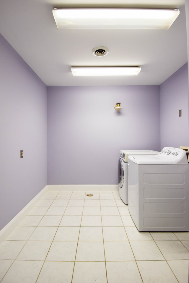 laundry room featuring light tile patterned floors and washer and dryer