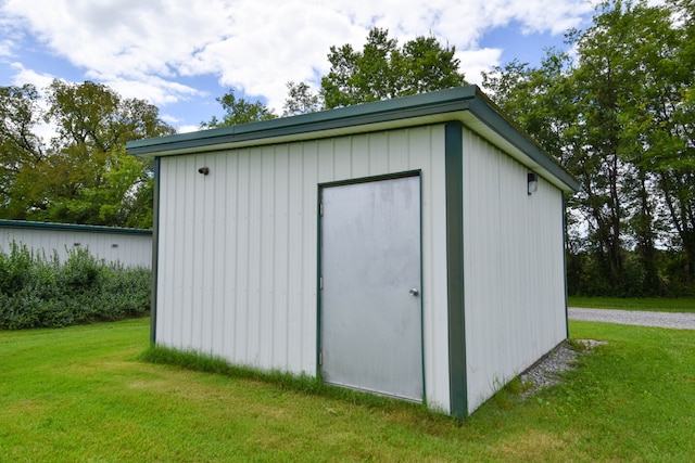 view of outdoor structure with a lawn