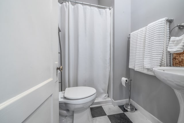 bathroom featuring walk in shower and toilet