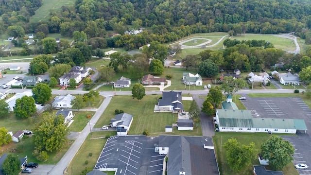 bird's eye view with a wooded view and a residential view