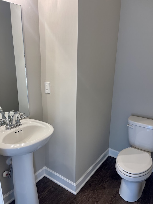 bathroom with sink, hardwood / wood-style floors, and toilet