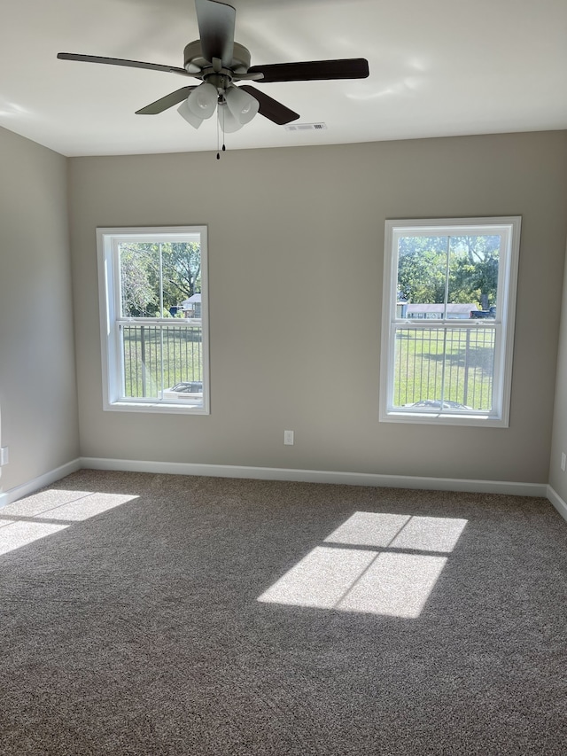 carpeted empty room featuring ceiling fan