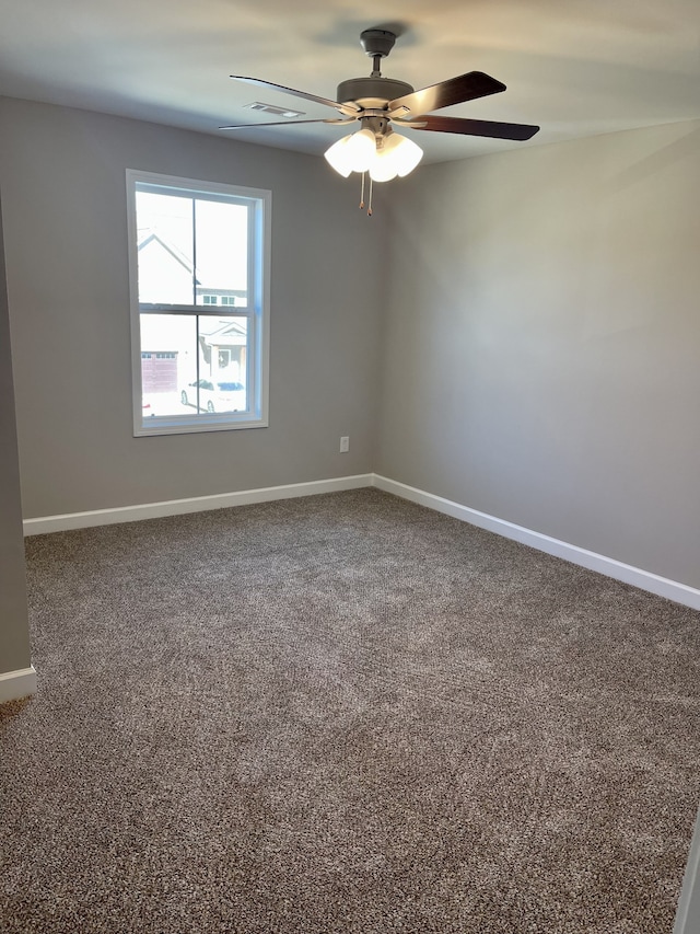 carpeted empty room featuring ceiling fan