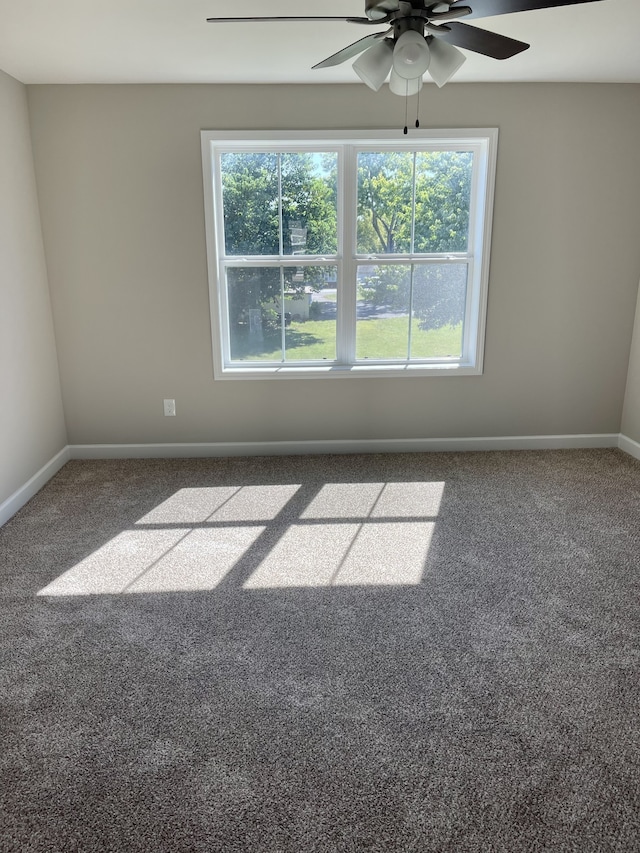 carpeted empty room with a healthy amount of sunlight and ceiling fan