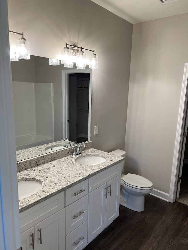 bathroom featuring hardwood / wood-style floors, vanity, and toilet