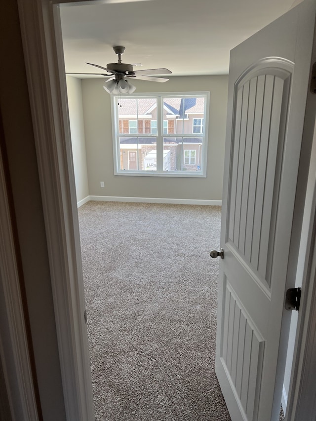 spare room featuring ceiling fan and carpet flooring