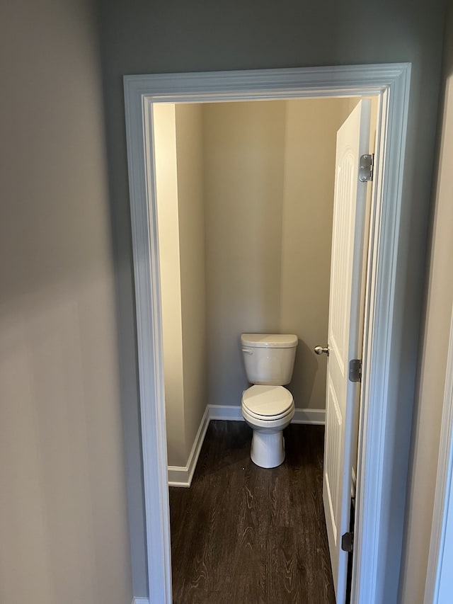 bathroom featuring wood-type flooring and toilet