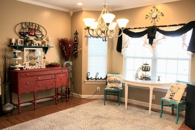 living area featuring wood-type flooring, a notable chandelier, and ornamental molding