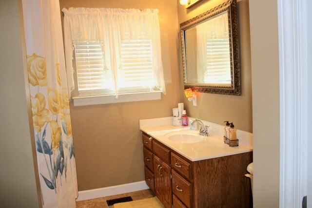 bathroom featuring a healthy amount of sunlight, tile patterned flooring, and vanity