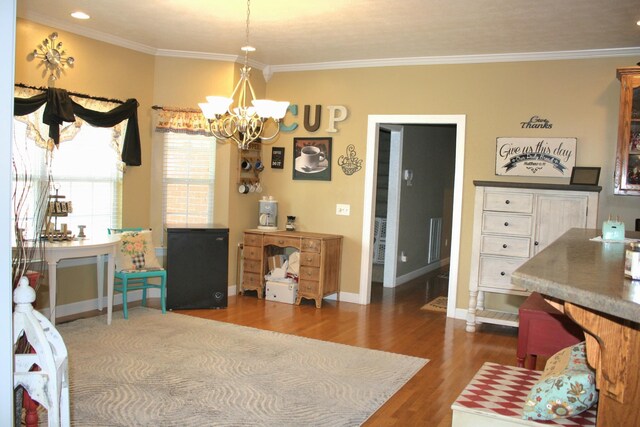 living room with an inviting chandelier, crown molding, and dark hardwood / wood-style flooring