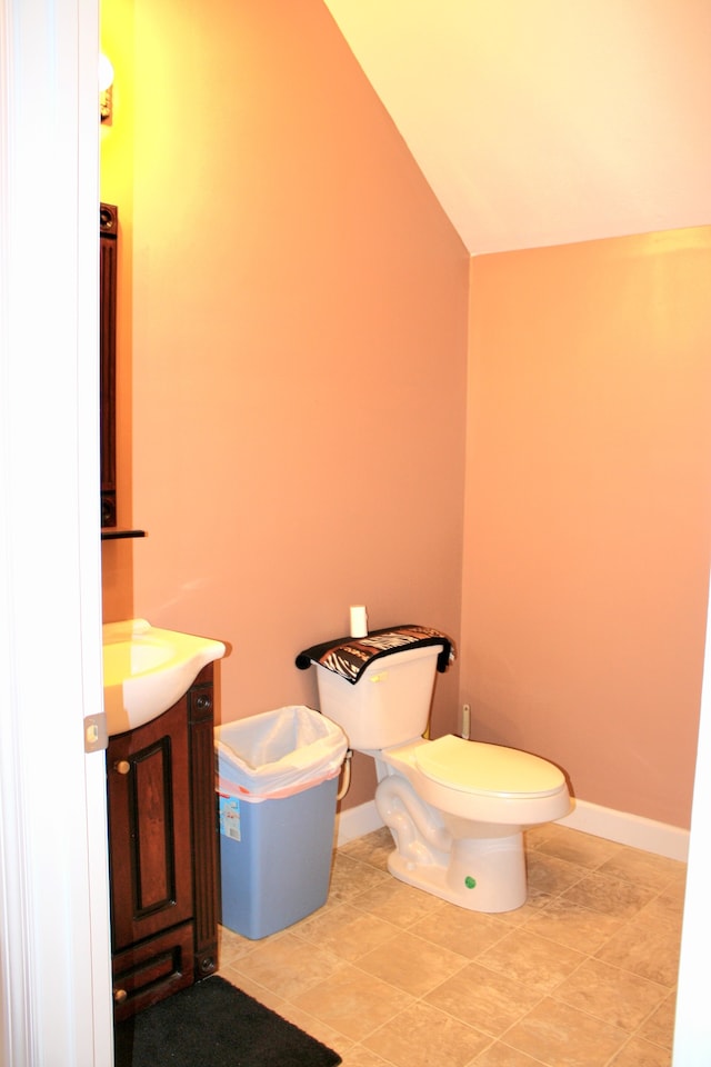 bathroom featuring vaulted ceiling, vanity, and toilet