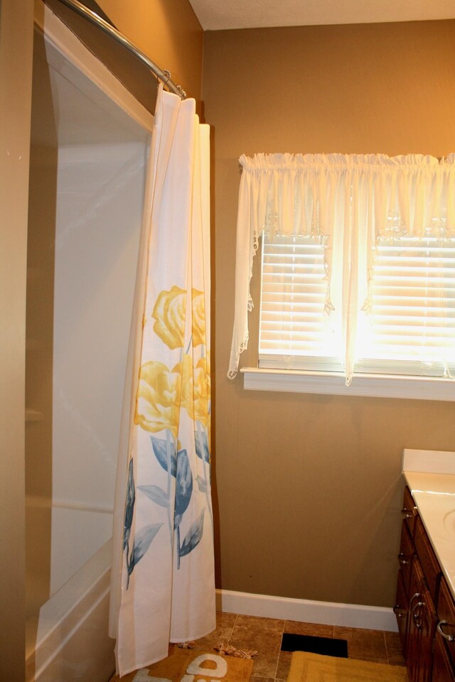 bathroom featuring shower / tub combo, tile patterned floors, and vanity