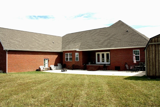 back of property with a patio and a yard