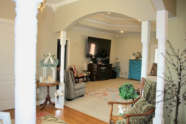 living room with ornamental molding, light hardwood / wood-style floors, and decorative columns