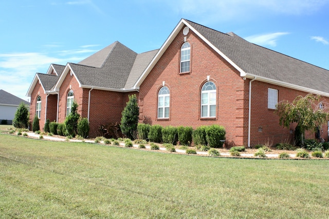 view of side of home featuring a lawn