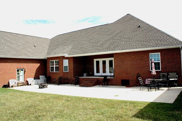 rear view of house featuring a yard, french doors, and a patio area