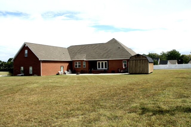 view of front facade with a storage shed and a front yard