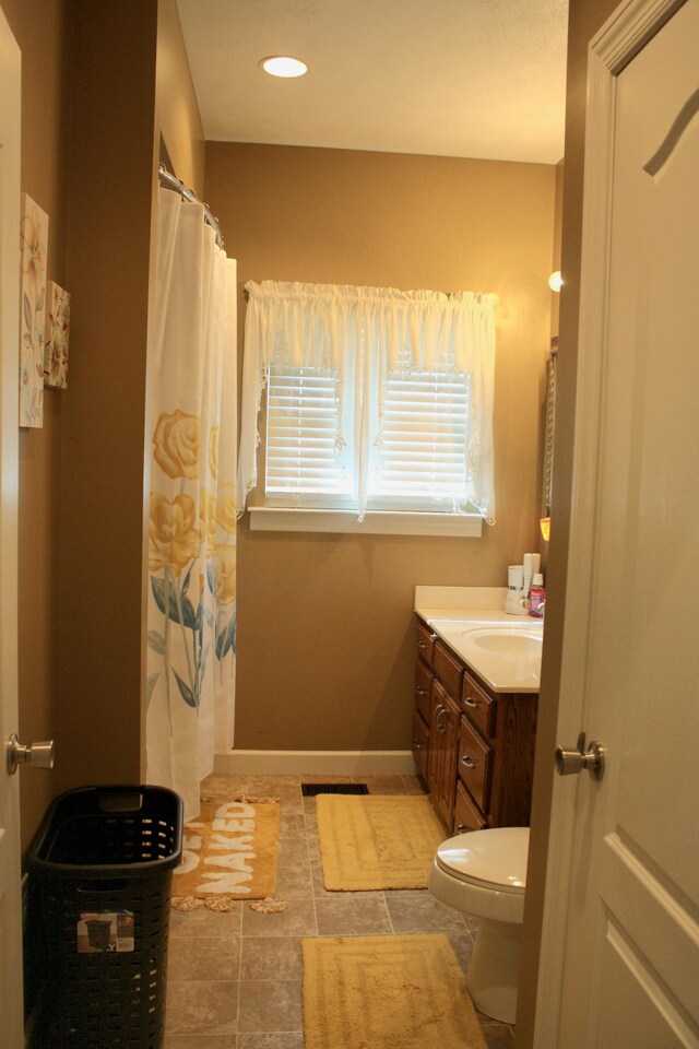 bathroom with vanity, toilet, and a shower with shower curtain