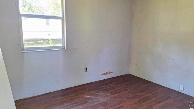 spare room with dark hardwood / wood-style flooring